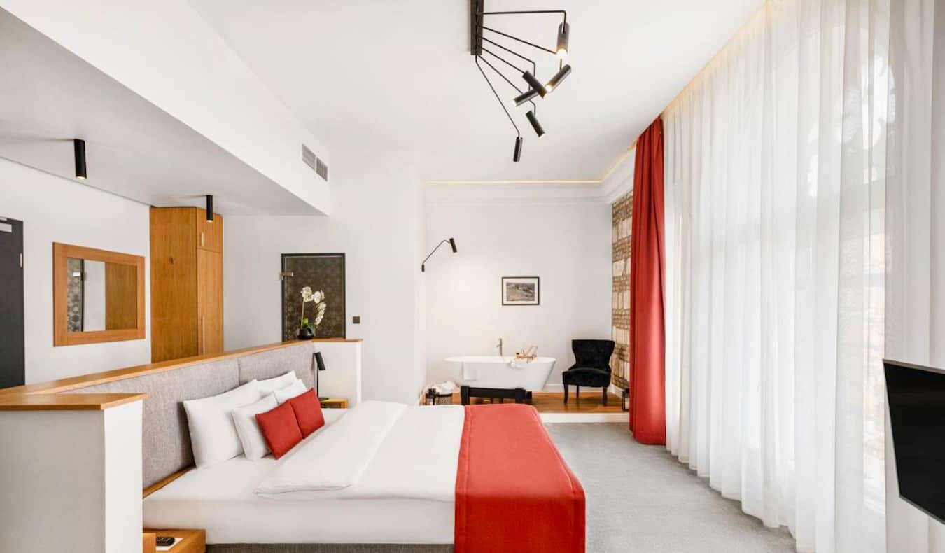 A large bed in an airy hotel room at the Monastery Boutique Hotel in Budapest, Hungary