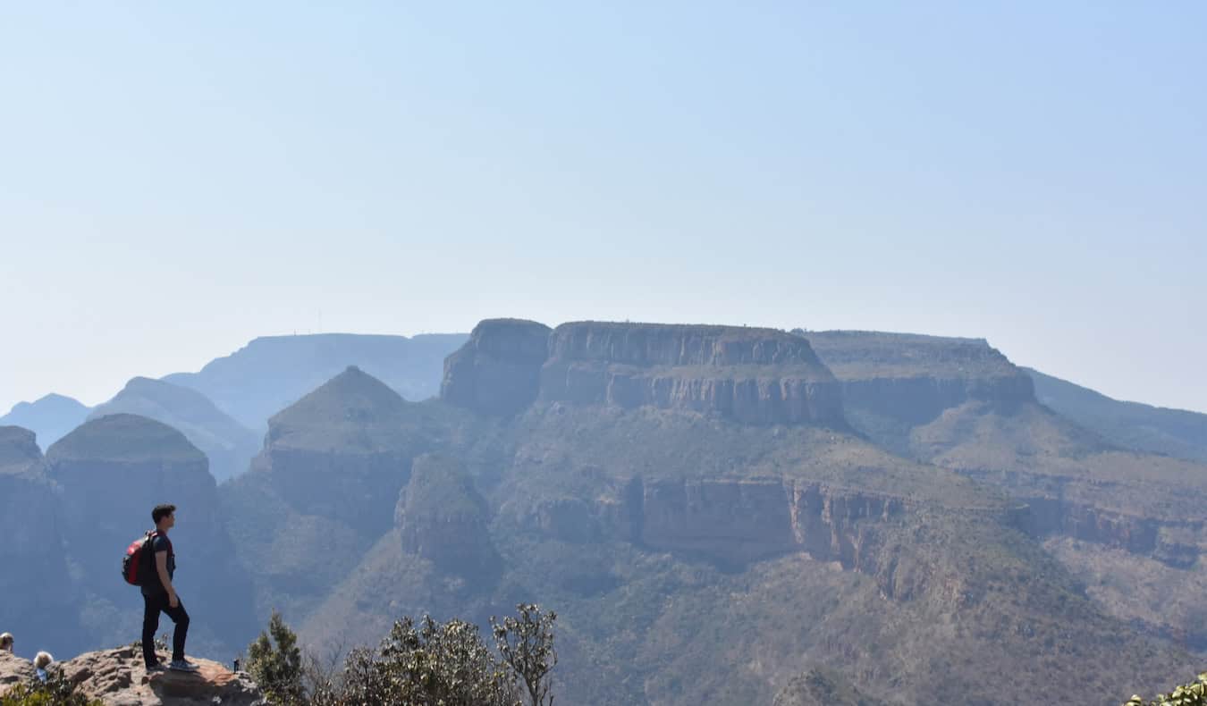 Nomadic Matt standing on a mountain looking out over the African landscape