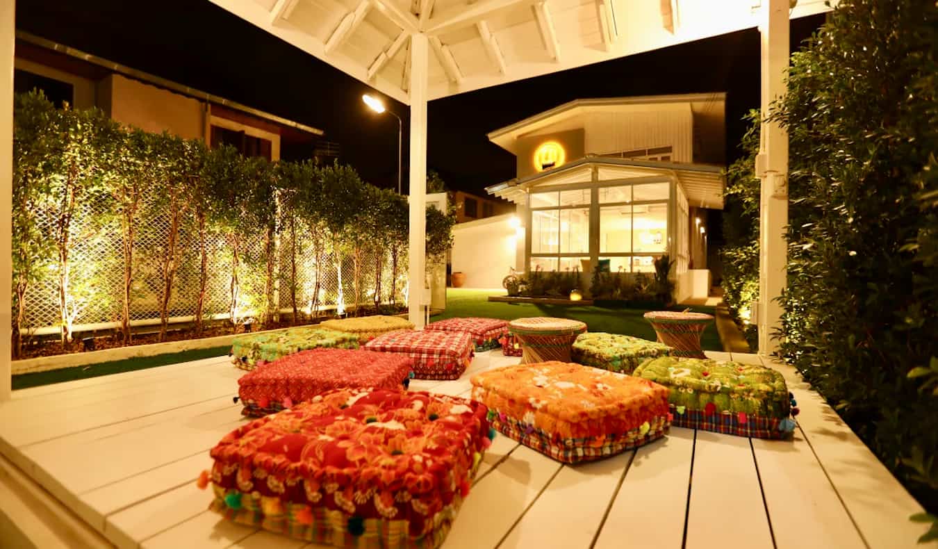 A relaxing outdoor common space at Hostel Lullaby in Chiang Mai, Thailand