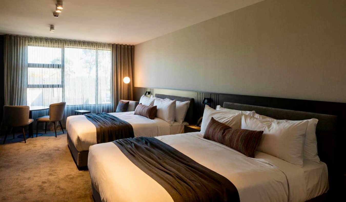 A large hotel room with two big, comfy beds in Christchurch, New Zealand