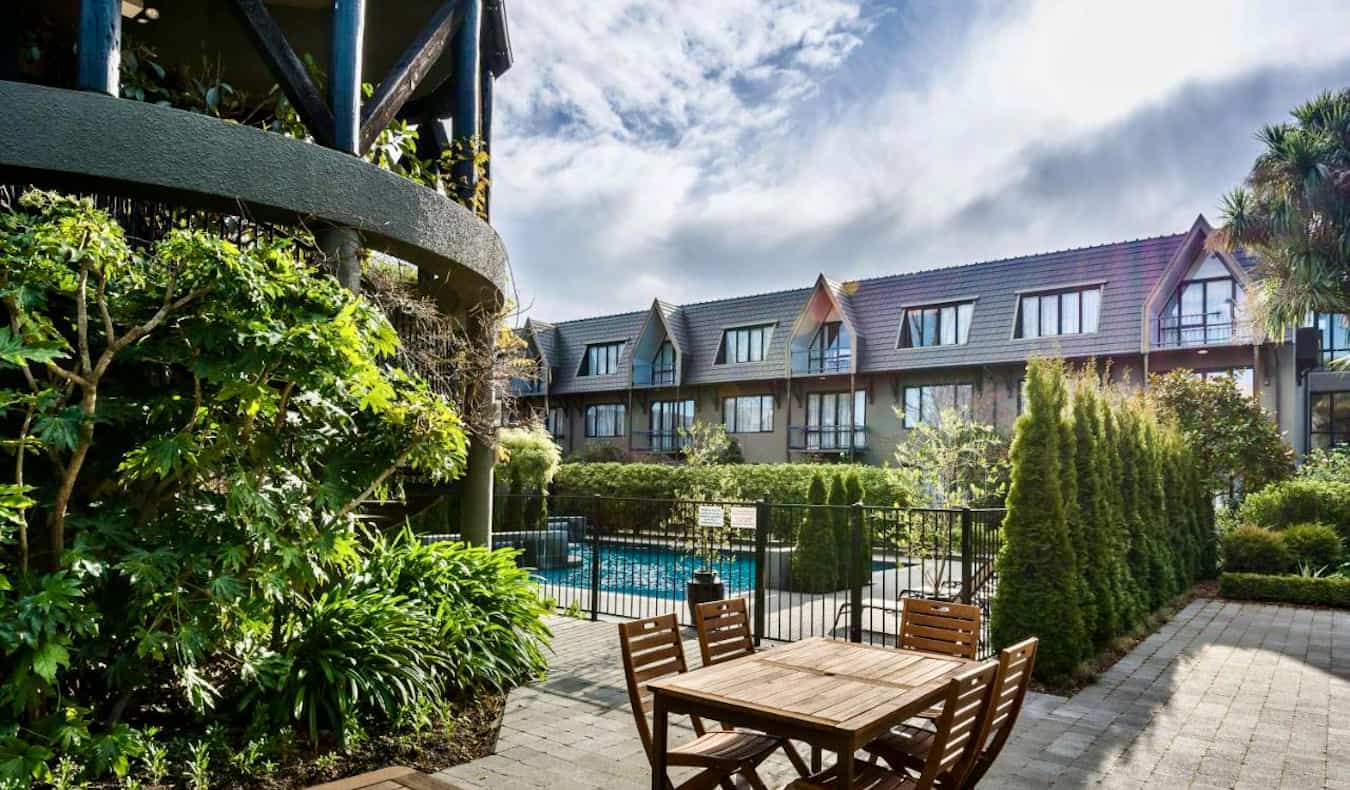 A relaxing outdoor lounge area near the pool at a hotel in Christchurch, New Zealand