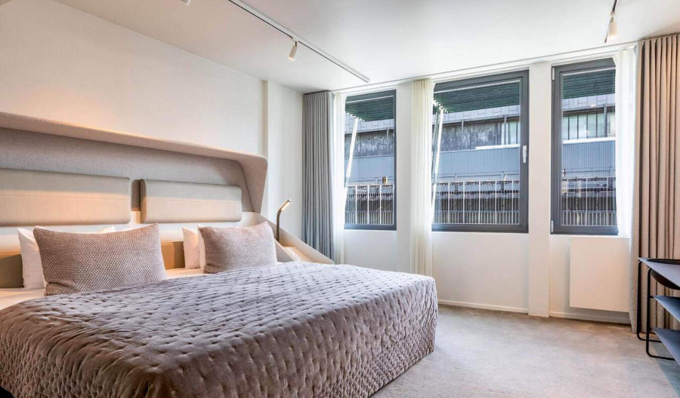 A large and minimalist hotel room at Hotel Herman K in Copenhagen, Denmark